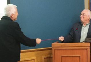 Mayor Vandewal and Deputy Mayor Leonard exchange a COVID-19 handshake